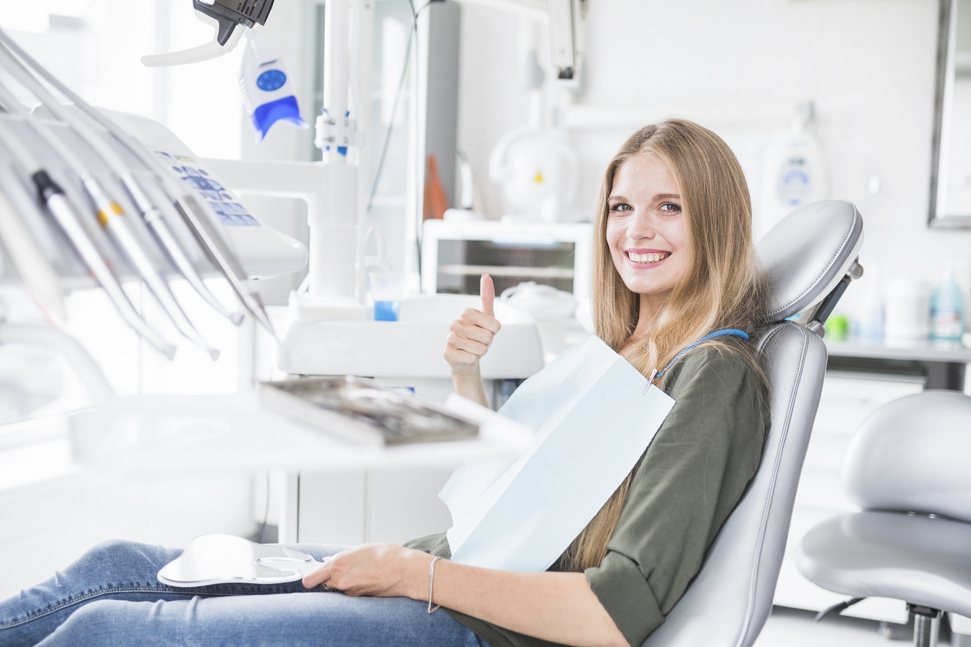Mature dentist holding large toothbrush and a denture stock image